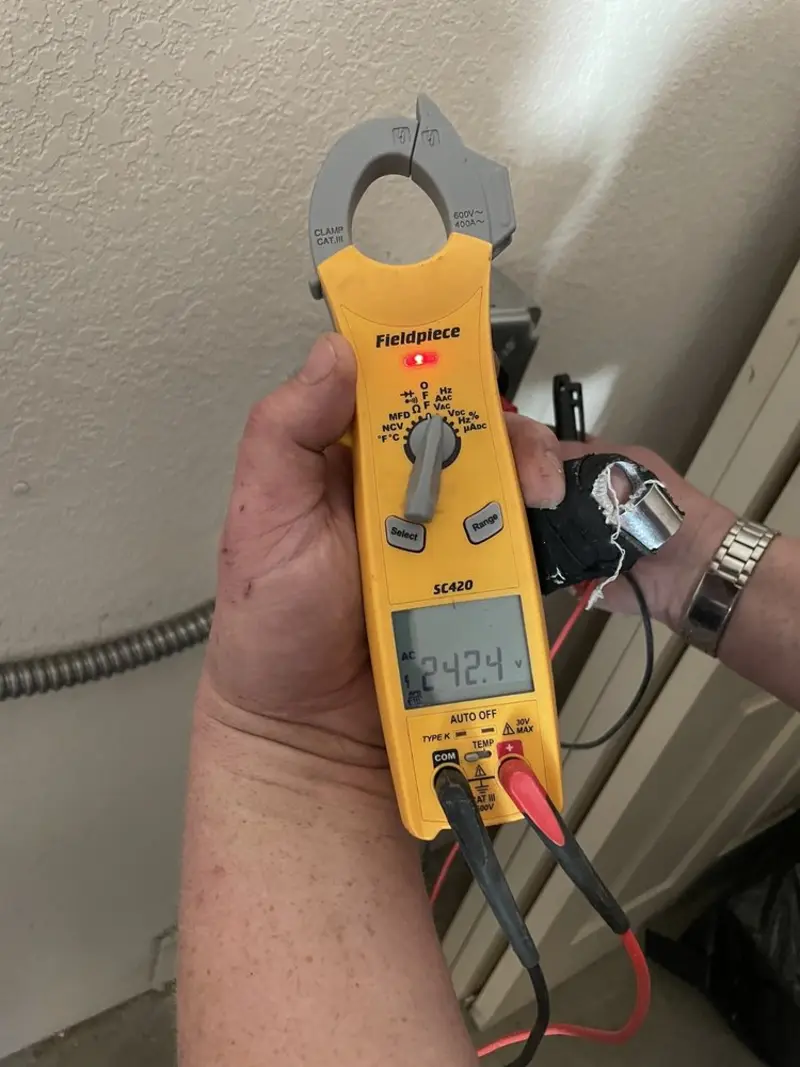 Voltage testing with clamp meter during Outlet Installation in Grafton